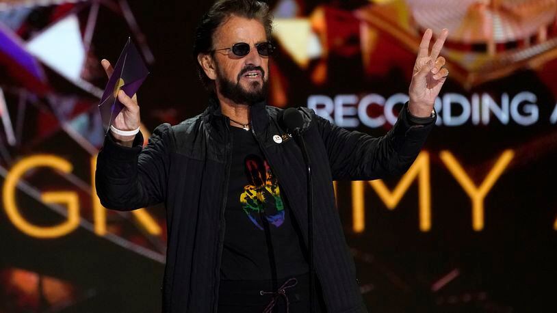 Ringo Starr gestures as he presents the award for record of the year at the 63rd annual Grammy Awards at the Los Angeles Convention Center on Sunday, March 14, 2021. (AP Photo/Chris Pizzello)
