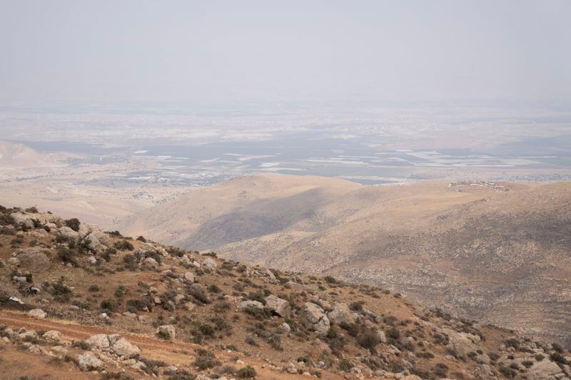 An Israeli settlers' outpost on a hilltop, right, is seen from outskirts of the West Bank town of Duma, Tuesday, April 30, 2024. (AP Photo/Nasser Nasser)