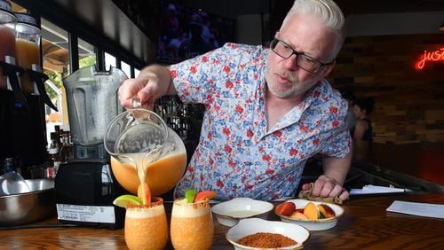 Bar(n) Booze (n) Bites in Dunwoody Village offers two frozen drinks, both created by Phil Handley, a partner with DASH Hospitality Group. Here, he pours The Spicy Peach Margarita. It's a frozen combination that includes peach puree, tequila, lime juice and agave nectar. (Styling by Phil Handley / Chris Hunt for the AJC)