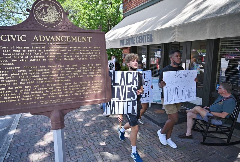 June 19, 2020 Madison - John Kirbymurdoch (left), 16  and Alex Williams (right), both 16 and students at Morgan County High School, lead a peaceful, youth-led march in downtown Madison on Friday, June 19, 2020. As protests in response to the death of George Floyd spread nationwide earlier this month, they started to pop up in some unexpected places: namely, the Atlanta exurbs, places like Cartersville, Peachtree City, Forsyth County, Braselton and Madison -- the predominantly white town about an hour east on I-20, whose main street is still lined with antebellum homes that Gen. Sherman purportedly found too beautiful to burn. (Hyosub Shin / Hyosub.Shin@ajc.com)