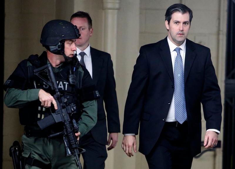 Michael Slager, at right, walks from the Charleston County Courthouse under the protection from the Charleston County Sheriff's Department after a mistrial was declared for his trial Monday Dec. 5, 2016, in Charleston, S.C. Former patrolman, Slager, was charged with murder in the April 4, 2015, shooting death of 50-year-old Walter Scott. (AP Photo/Mic Smith)
