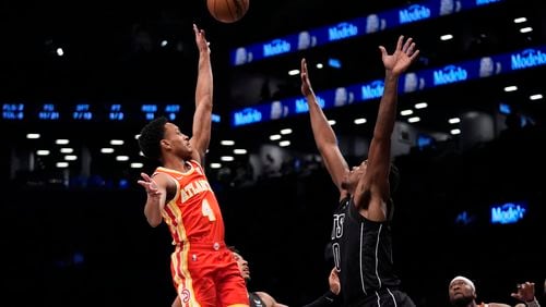 Atlanta Hawks' Kobe Bufkin (4) shoots over Brooklyn Nets' Day'Ron Sharpe (20) during the first half of an NBA basketball game Thursday, Feb. 29, 2024, in New York. (AP Photo/Frank Franklin II)