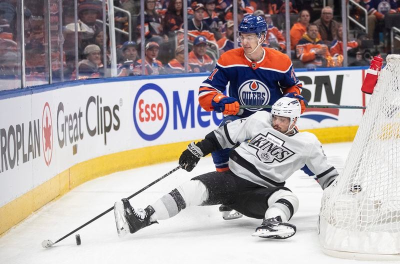 Los Angeles Kings' Kevin Fiala (22) and Edmonton Oilers' Ryan McLeod (71) vie for the puck during the first period of Game 2 of an NHL hockey Stanley Cup first-round playoff series Wednesday, April 24, 2024, in Edmonton, Alberta. (Jason Franson/The Canadian Press via AP)