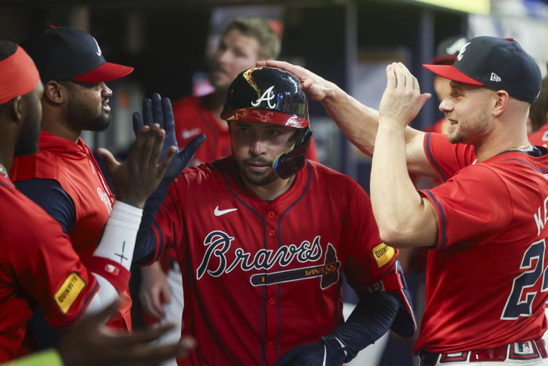 Atlanta Braves catcher Travis d'Arnaud celebrates his home run in the dugout during the fifth inning. (Jason Getz / AJC)
