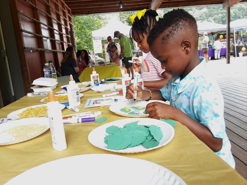 Two children perfect their artwork at the Chattahoochee Nature Center’s annual Flying Colors 
Butterfly Festival at the Chattahoochee Nature Center.
Courtesy of the Chattahoochee Nature Center.