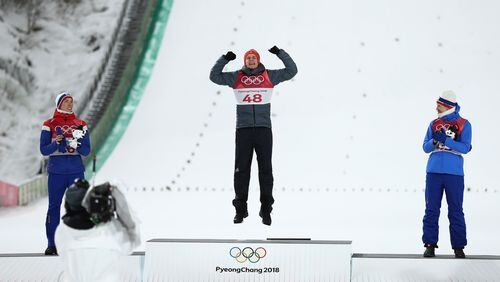 PYEONGCHANG-GUN, SOUTH KOREA - FEBRUARY 10: Gold medalist Andreas Wellinger of Germany (C) celebrates on the podium alongside silver medalist Johann Andre Forfang of Norway (L) and bronze medalist Robert Johansson of Norway (R) during the victory ceremony for the Ski Jumping - Men's Normal Hill Individual Final on day one of the PyeongChang 2018 Winter Olympic Games at Alpensia Ski Jumping Center on February 10, 2018 in Pyeongchang-gun, South Korea. (Photo by Lars Baron/Getty Images)