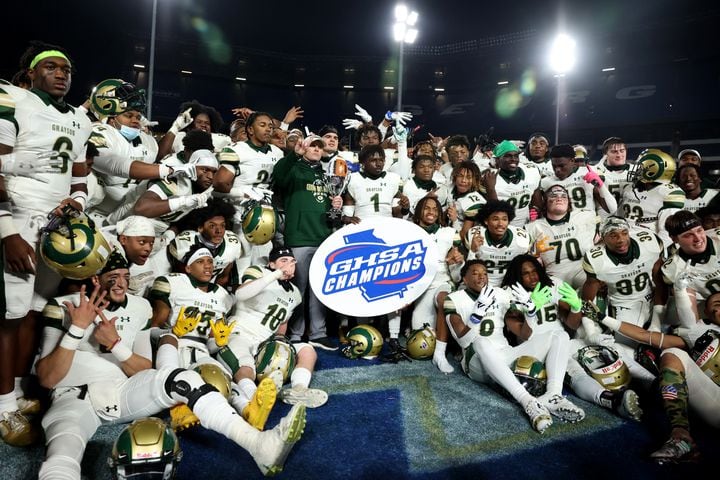 Dec. 30, 2020 - Atlanta, Ga: Grayson players and coaches pose with the trophy after their 38-14 win against Collins Hill during the Class 7A state high school football final at Center Parc Stadium Wednesday, December 30, 2020 in Atlanta. JASON GETZ FOR THE ATLANTA JOURNAL-CONSTITUTION