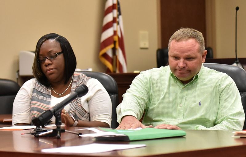Randolph County Board of Elections members Michele Graham and Scott Peavy vote “No” to a proposal to close seven rural voting locations during a meeting Friday at the Randolph County Government Center in Cuthbert. HYOSUB SHIN / HSHIN@AJC.COM