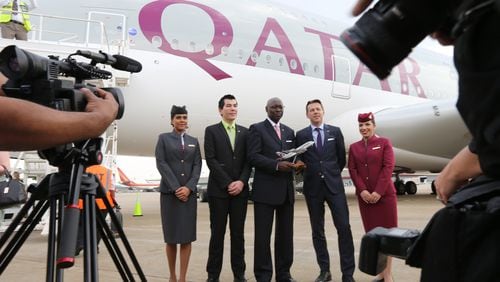 Qatar Airways flight attendants pose for a photo with executives at the inaugural flight from Atlanta to Doha on June 1, 2016. Ben Gray / bgray@ajc.com