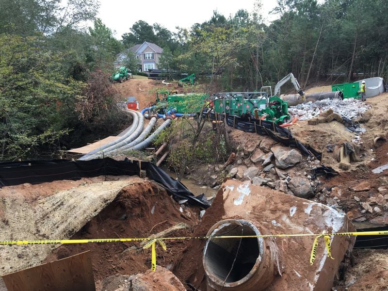 Contractors for DeKalb County were repairing large sewer pipes near Snapfinger Creek on Monday, Oct. 2, 2017. The pipes burst in August, spilling 6.4 million gallons of sewage. MARK NIESSE / MARK.NIESSE@AJC.COM