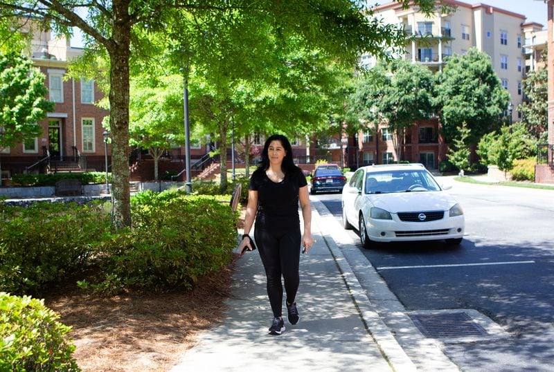 Michelle Enjoli walks through her gated community on Thursday, May 2, 2021, in Sandy Springs, Georgia. Enjoli moved from a crowded area in Buckhead to a gated community in Sandy Springs after starting a business and transitioning to working at home full-time. (Christina Matacotta for The Atlanta Journal-Constitution)