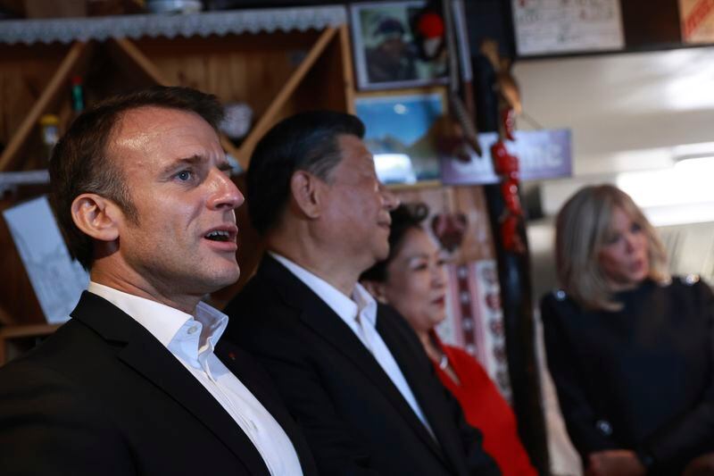 French President Emmanuel Macron, left, sings in a restaurant after a lunch in a restaurant with Chinese President Xi Jinping, second left, his wife Peng Liyuan, and Brigitte Macron, right, Tuesday, May 7, 2024 at the Tourmalet pass, in the Pyrenees mountains. French president is hosting China's leader at a remote mountain pass in the Pyrenees for private meetings, after a high-stakes state visit in Paris dominated by trade disputes and Russia's war in Ukraine. French President Emmanuel Macron made a point of inviting Chinese President Xi Jinping to the Tourmalet Pass near the Spanish border, where Macron spent time as a child visiting his grandmother. (AP Photo/Aurelien Morissard, Pool)