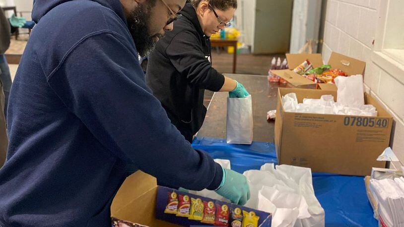 About 1,500 food boxes are needed to be packed by volunteers with donated goods for children out of school and parents out of work over the next two weeks due to the COVID-19 virus. (Courtesy of Cobb County School District)
