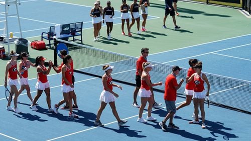 The University of Georgia women's tennis team celebrates after winning the doubles point over Virginia on the the way to a 4-1 victory in the round of 16 at the NCAA Tennis Championships (Manuela Davies/USTA)