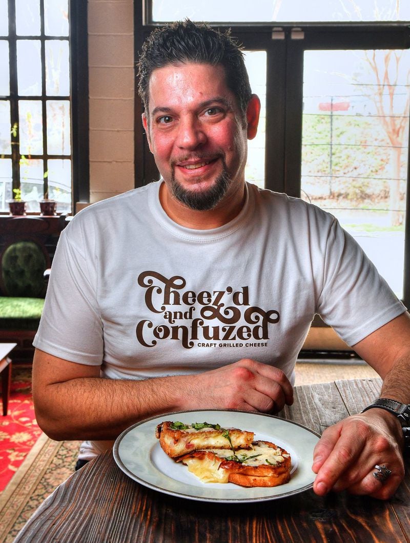 Daniel Ray, shown with his Torched Sicilian, now operates Cheez’d and Confuzed, catering grilled cheese parties around Atlanta. STYLING BY DANIEL RAY / CONTRIBUTED BY CHRIS HUNT PHOTOGRAPHY