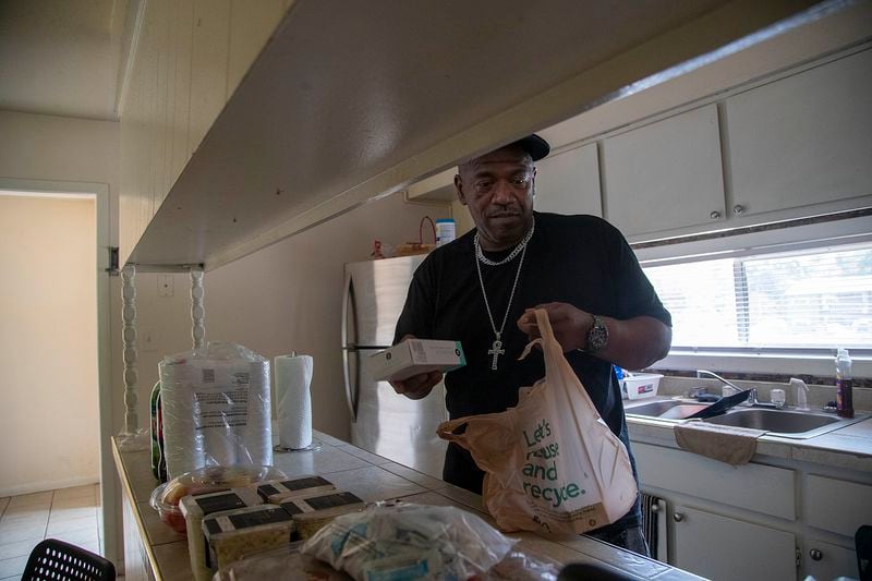 Antonio Bryant prepares food items for a community meeting at his residence in Morrow, Thursday, Aug. 12, 2021.  (Alyssa Pointer/Atlanta Journal Constitution)