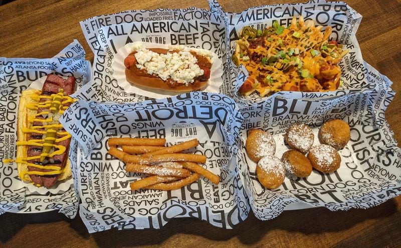 This selection of items from The Hot Dog Factory includes, clockwise from left, Polish Street Dog, Carolina Slaw Dog, loaded fries, deep-fried Oreos and funnel cake sticks. PAULA PONTES