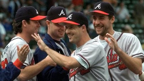 Braves pitchers Mike Cather (from left), Alan Embree and John Smoltz (right), congratulate Greg Maddux (center) after he threw a five hitter Tuesday, July 22, 1997, against the Chicago Cubs in Chicago. The Braves defeated the Cubs 4-1 in the first game of a doubleheader. (Michael S. Green/AP)
