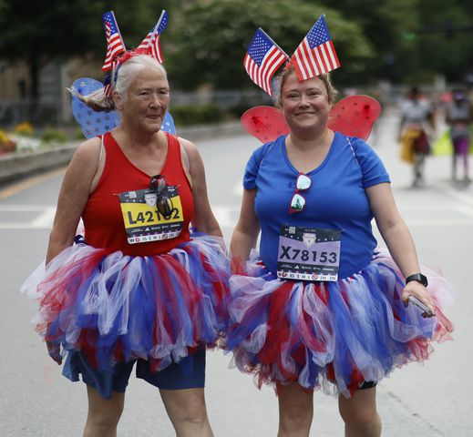 Runners make their way up Peachtree Street during the 54th running of the Atlanta Journal-Constitution Peachtree Road Race in Atlanta on Tuesday, July 4th, 2023.   (Miguel Martinez / Miguel.MartinezJimenez@ajc.com)