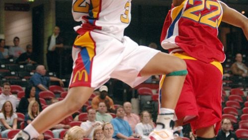 In this photo provided by McDonald's, McDonald's All-American East player Maya Moore, left,  of Lawrenceville, Ga., drives past the West team's Victoria Baugh (22),  of Sacramento, Calif.,  during the 30th anniversary McDonald's All American High School Basketball Game, Wednesday, March 28, 2007, in Louisville, Ky.   (AP Photo/McDonald's, Henny Ray Abrams, HO) 