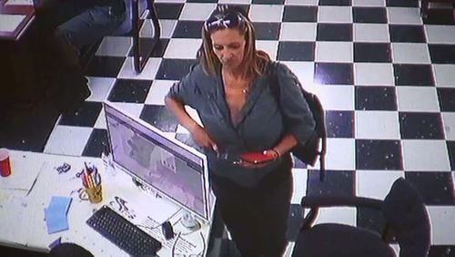 A woman seen on surveillance video is suspected of stealing a minivan from a Hall County dealership. (Credit: Channel 2 Action News)