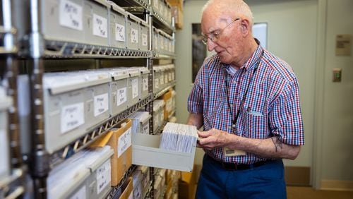 Guy "Mac" McGowan, 96, sorts through voter registration cards as he helps maintain Muskogee County's voter registration lists in Columbus. (Nathan Posner for The Atlanta Journal-Constitution)