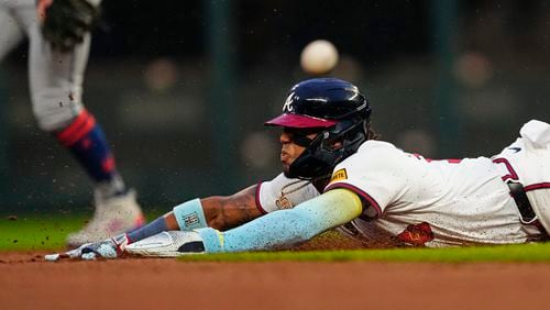 Atlanta Braves outfielder Ronald Acuña Jr. (13) beats the throw as he steals second base in the foirst inning of a baseball game against the New York Mets Tuesday, April 9, 2024, in Atlanta. (AP Photo/John Bazemore)
