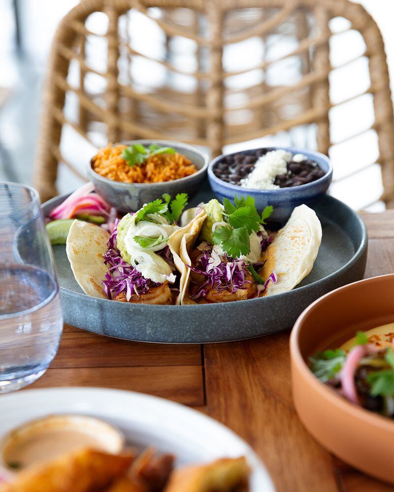 You can get two grilled shrimp tacos served with red cabbage, poblano crema, coconut curry, guacamole and cilantro at Gezzo's Coastal Cantina. Courtesy of Order Up/Sharon Benton Studio