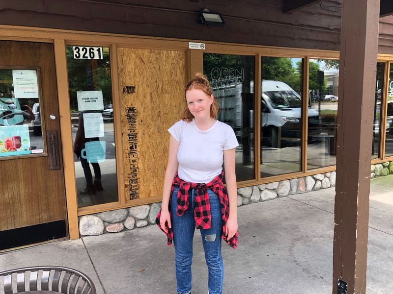 Danny Allen, general manager of Caribou Coffee, said the Midtown coffee shop only suffered the loss of one window and some broken cash registers. “The stores down there have it worse,” she said of her neighbors. LEON STAFFORD/STAFF