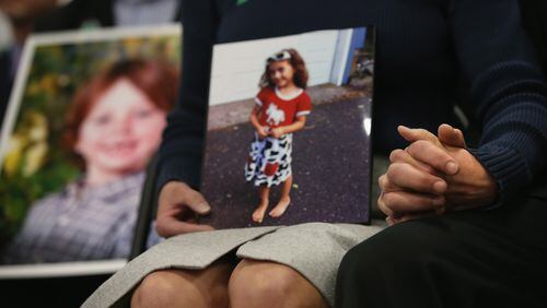 NEWTOWN, CT - JANUARY 14: Parents of Sandy Hook Elementary massacre victims hold hands during a press conference on the one month anniversary of the Newtown elementary school massacre on January 14, 2013 in Newtown, Connecticut. The shooting was an inspiration for the “Stop the Bleed” program. (Photo by John Moore/Getty Images)
