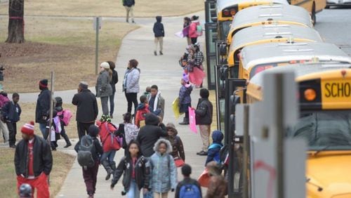 Students head to waiting buses as they dismiss early from Woodridge Elementary School on Friday Jan. 6, 2017. KENT D. JOHNSON/ KDJOHNSON@AJC.COM