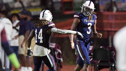 Pebblebrook wide receiver Christian Vega (14) celebrates with teammate Craig Adams, Jr. (3) after Adams scores a touchdown in the first half of Friday's Pebblebrook-North Atlanta game at Pebblebrook.