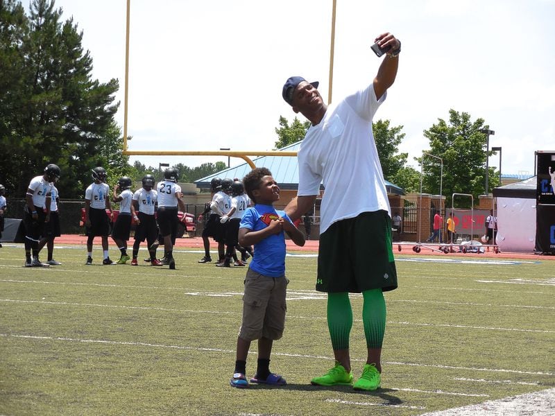 Cam Newton poses for the cutest selfie ever during his youth football game. He is committed to philanthropy and family in addition to football and champions "the power of giving back." Photo: Jennifer Brett