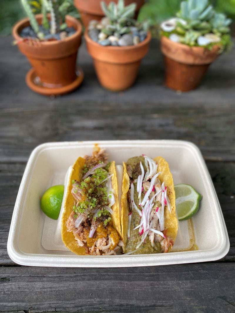 An order of takeout tacos from Gato in Candler Park includes (on the left) pulled citrus pork shoulder, with smoked peach salsa, cilantro stem, iced red onion, and chapulines salt; and (on the right) braised turkey thigh with green mole and radish. Wendell Brock for The Atlanta Journal-Constitution