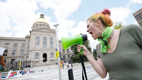 Amber R. chants with a megaphone July 3, 2022, outside the Georgia State Capitol in Atlanta to protest the U.S. Supreme Court reversal of Roe v Wade. Sunday, July 3, 2022.  (Miguel Martinez / Miguel.martinezjimenez@ajc.com)
