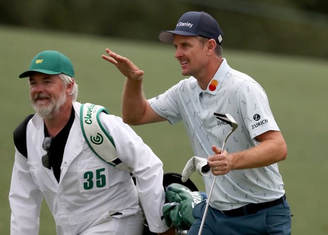 Justin Rose and his caddie David Clark react to his second shot on the eighteenth hole during the first round of the Masters at Augusta National Golf Club on Thursday, April 8, 2021, in Augusta. Curtis Compton/ccompton@ajc.com