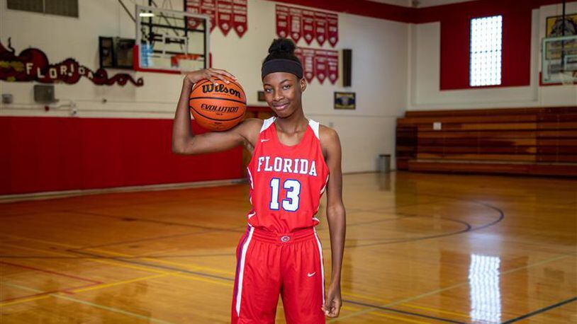 Florida School for the Deaf & Blind center Kayla Debrow (13) poses with a basketball during the Dragons' 2021-22 season. (Courtesy FSDB Athletics)