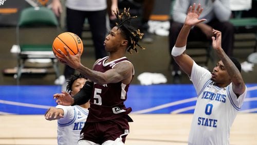 Mississippi State guard Deivon Smith (5) goes up for a shot after getting past Memphis guard Boogie Ellis (left, rear) and D.J. Jeffries (0) in the second half of NIT championship game Sunday, March 28, 2021, in Frisco, Texas. Memphis won 77-65. (Tony Gutierrez/AP)