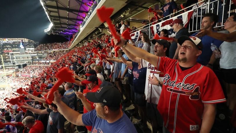 Braves fans participate in the tomahawk chop before a 2018 playoff game at SunTurst Park (now Truist Park).