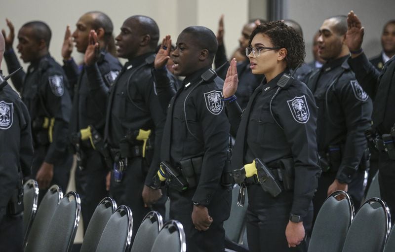 New officers take their oath at the DeKalb County 114th Police Academy graduation ceremony on Friday, Dec. 14, 2018 at the Manuel J. Maloof Auditorium in Decatur. The new graduates became officers just one day after DeKalb County Police Officer Edgar Flores, age 24, was fatally gunned down in the line of duty. 
