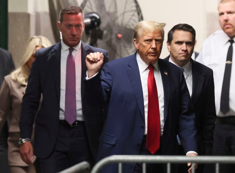 Republican presidential candidate and former U.S. President Donald Trump gestures while he walks, as his criminal trial over charges that he allegedly falsified business records to conceal money paid to silence porn star Stormy Daniels in 2016 continues, at Manhattan state court in New York, Tuesday, April 23, 2024. (Brendan McDermid/Pool Photo via AP)