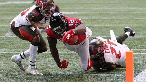 October 14, 2018 Atlanta: Atlanta Falcons wide receiver Mohamed Sanu dives into the endzone past Tampa Bay Buccaneers safety Justin Evans and cornerback Ryan Smith for a 7-6 lead during the first quarter in a NFL football game on Sunday, Oct 14, 2018, in Atlanta.   Curtis Compton/ccompton@ajc.com
