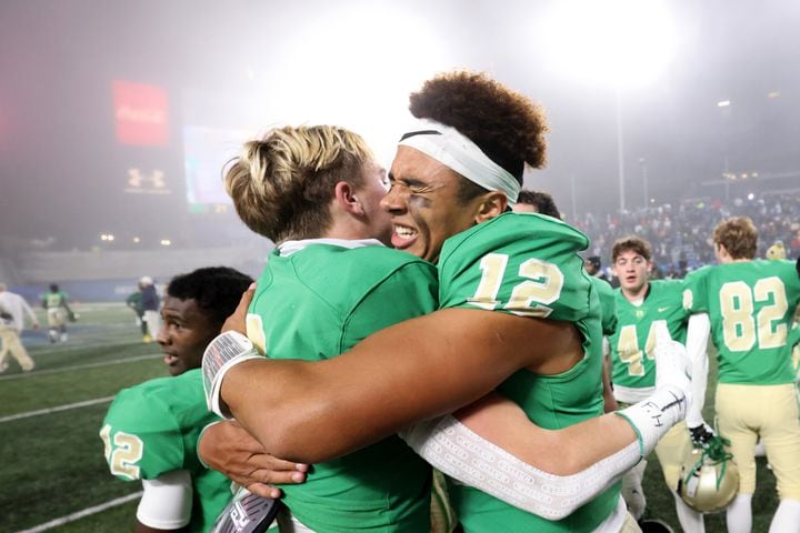 Buford defensive back Jake Pope (2) celebrates with quarterback Ashton Daniels (12) after their 21-20 win against Langston Hughes during the Class 6A state title football game at Georgia State Center Parc Stadium Friday, December 10, 2021, Atlanta. JASON GETZ FOR THE ATLANTA JOURNAL-CONSTITUTION