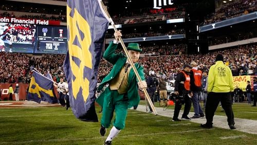 The Notre Dame mascot carries a flag on the field before an NCAA college football game against Temple Saturday, Oct. 31, 2015, in Philadelphia. (AP Photo/Mel Evans)