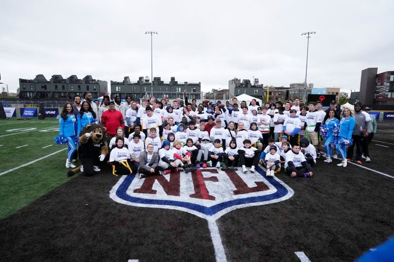 Participants in the NFL Football Play Football Prospect Clinic with Special Olympics athletes pose with NFL prospects after their clinic, Wednesday, April 24, 2024 in Detroit. (AP Photo/Carlos Osorio)