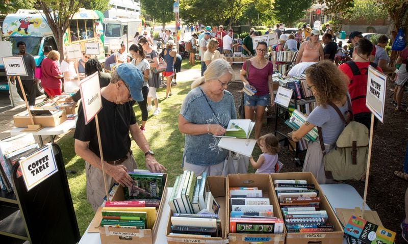 Carolyn Haessler (center) looks over some dollar gardening books at the Friends of Decatur Library book sale during the 2018 AJC Decatur Book Festival.  (Photo: STEVE SCHAEFER / SPECIAL TO THE AJC)