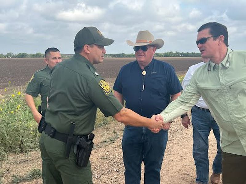 Republican U.S. Rep. Austin Scott of Tifton shakes hands with a U.S. Customs and Border Patrol agent while Agriculture Committee Chairman Glenn Thompson looks on during a visit to the border with Mexico. Scott has pressed President Joe Biden to do more to limit illegal immigration. Photo courtesy of Rep. Scott, U.S. House of Representatives.