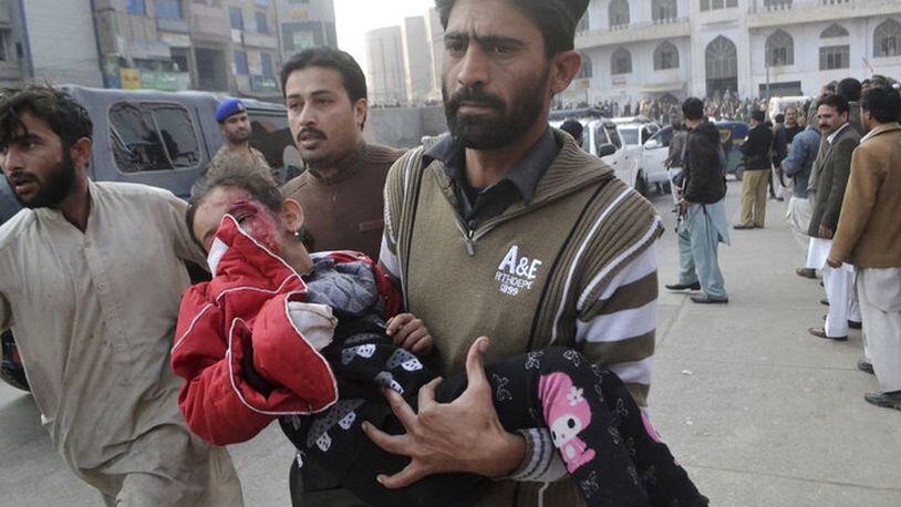 A young Pakistani girl, victim of a terrorist attack, is rushed to a hospital in Peshawar. (AP)
