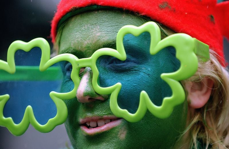 A woman wearing tinted shamrock glasses watches the 243rd Anuual St. Patrick's Day Parade March 17, 2004 in New York City.