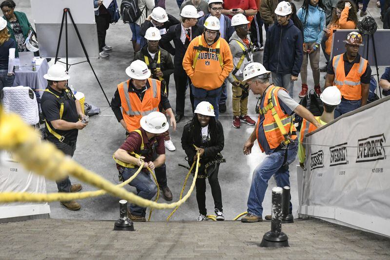 Tatyana Seals of DeKalb Alternative School, center, gets ready to ascend a roof during the SkillsUSA State Championship, Friday March 23, 2018, at the Georgia International Convention Center, March 23, 2018. (John Amis)